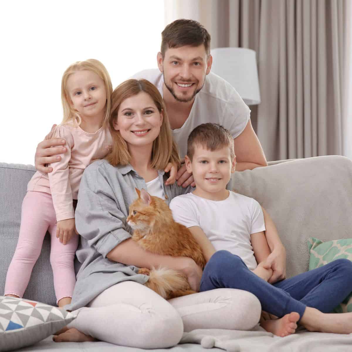 family with cat on the couch