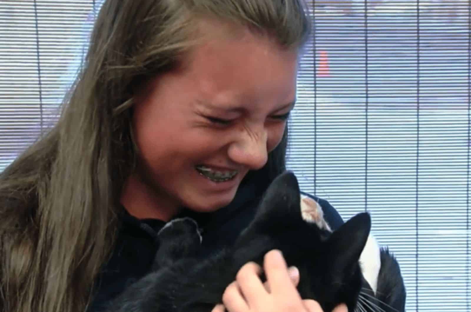 happy woman holding a black cat