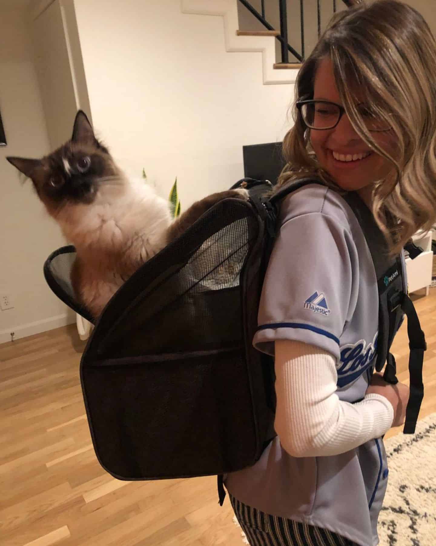woman with cat in bag