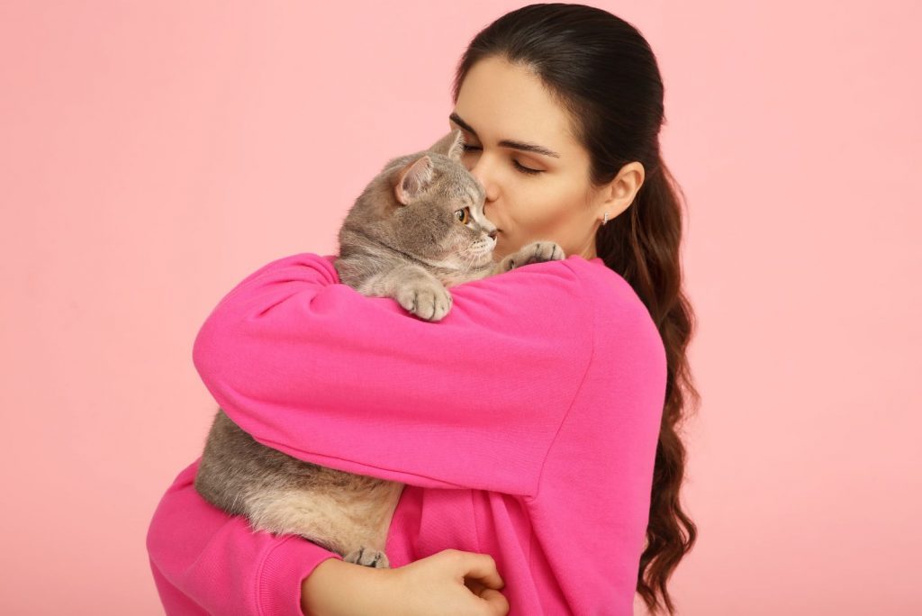 a cat in womans arms