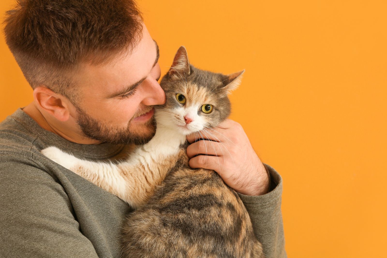 a man holding a cat