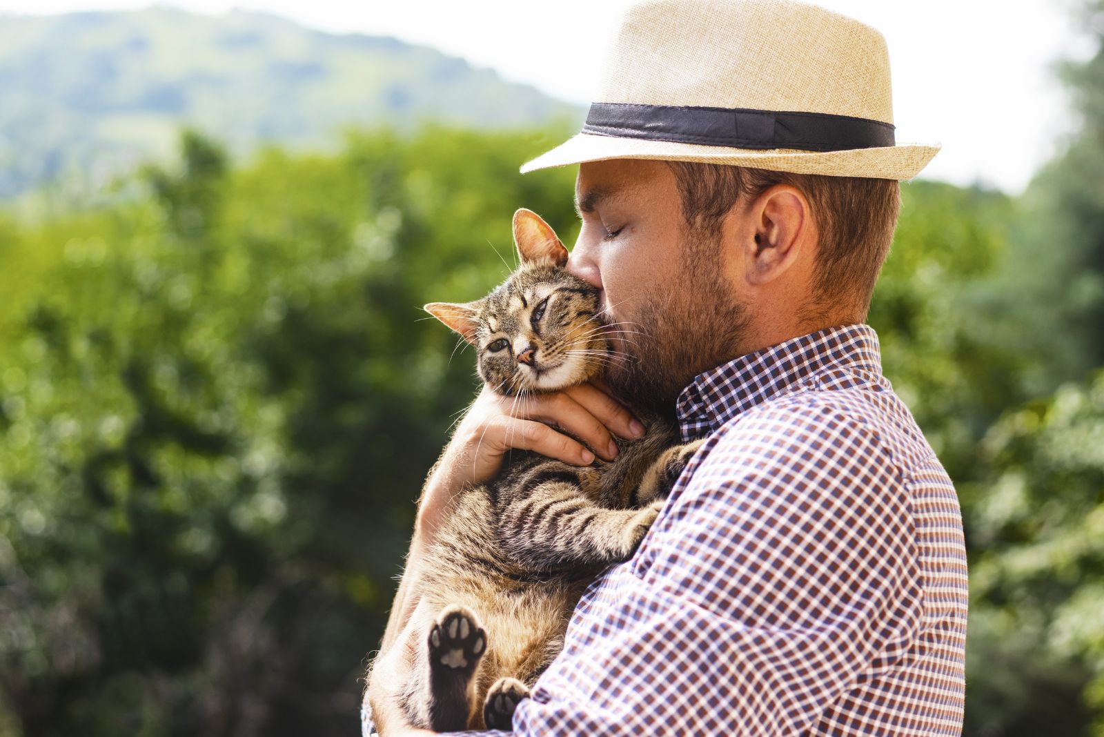 a man kissing a cat