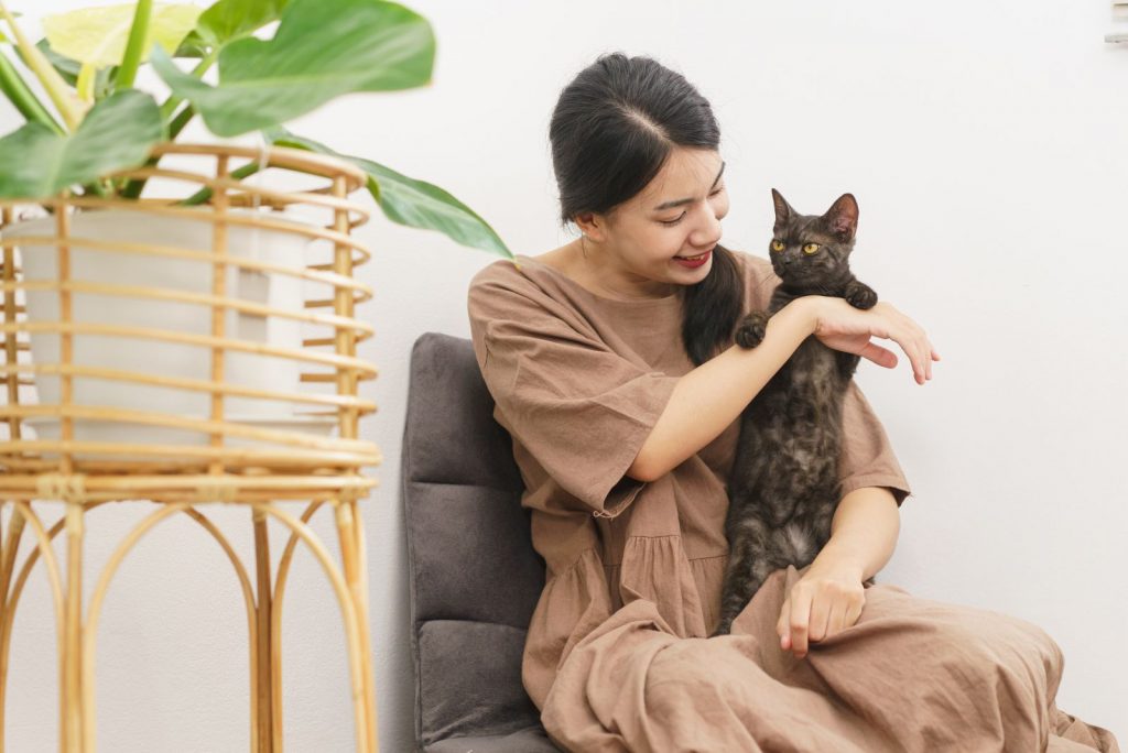 a woman playing with her cat