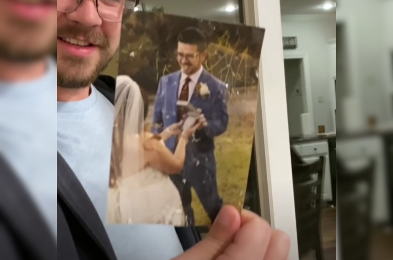 man holding a wedding photo