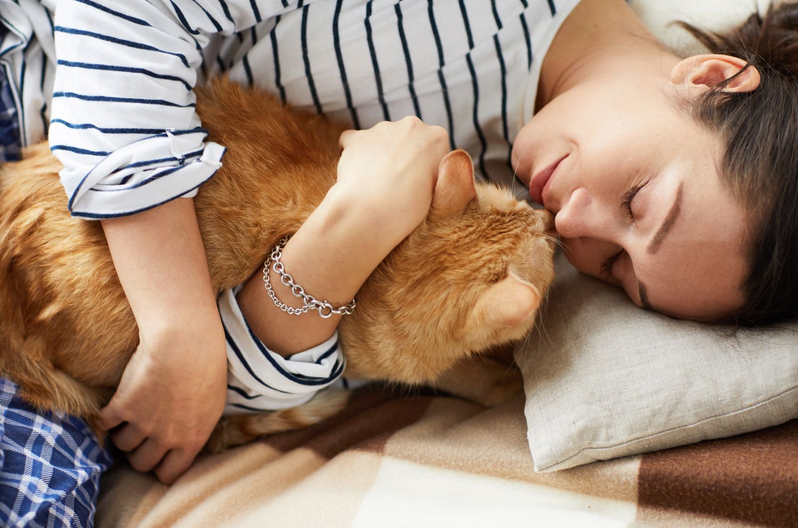 woman cuddling a cat