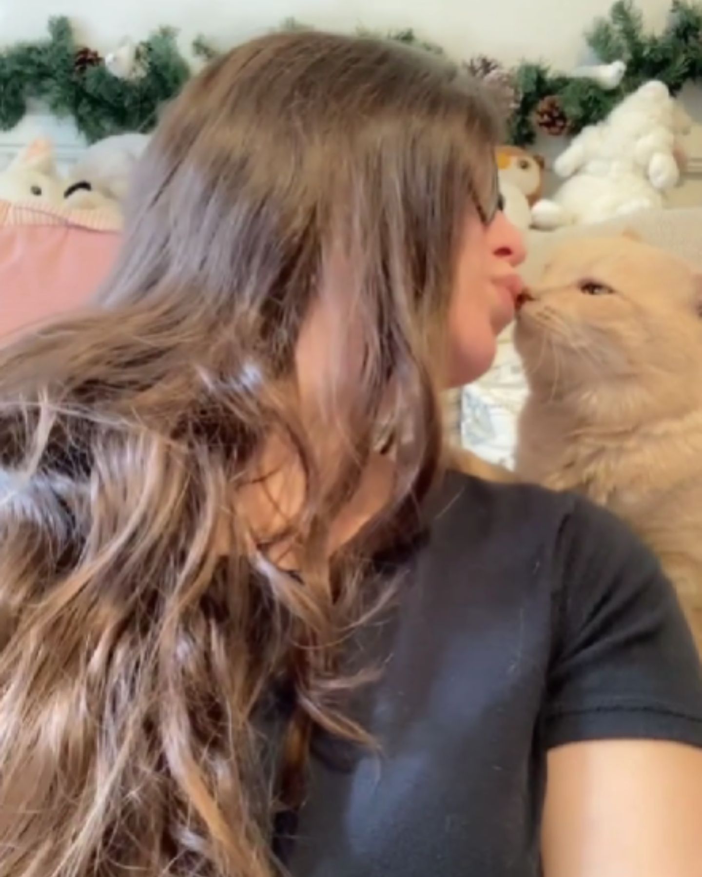 woman giving cat a kiss
