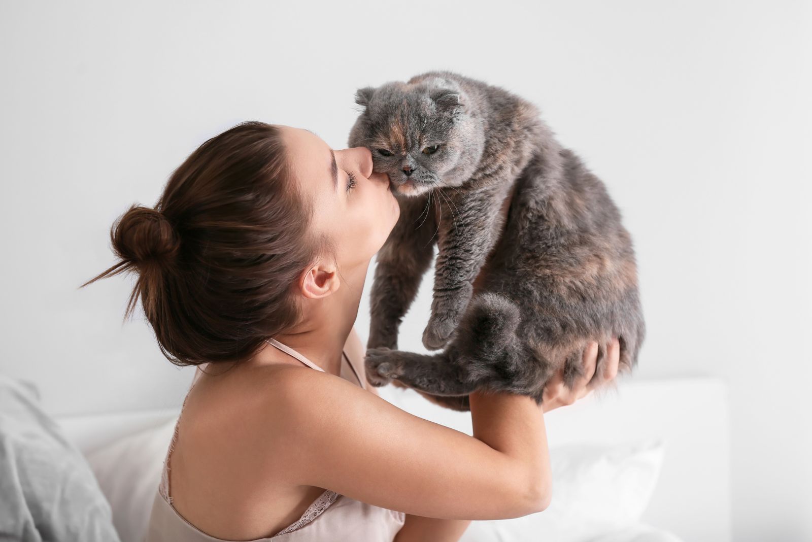 woman kissing a cat