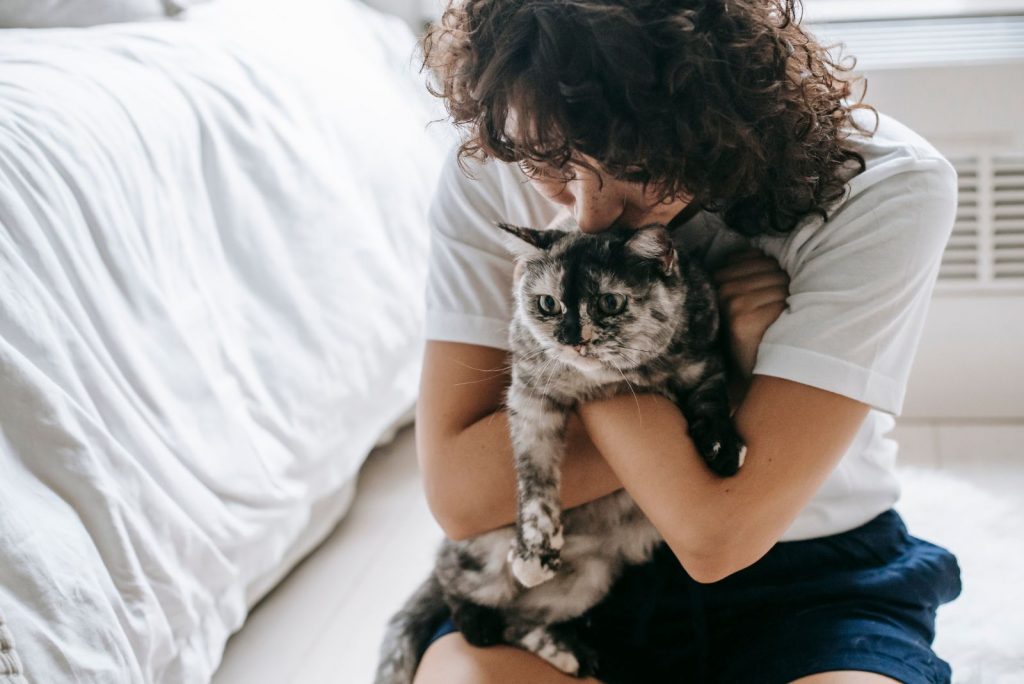 woman kissing cats head