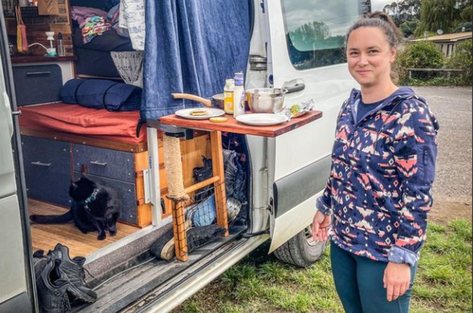 woman-next-to-a-cat-in-a-camper