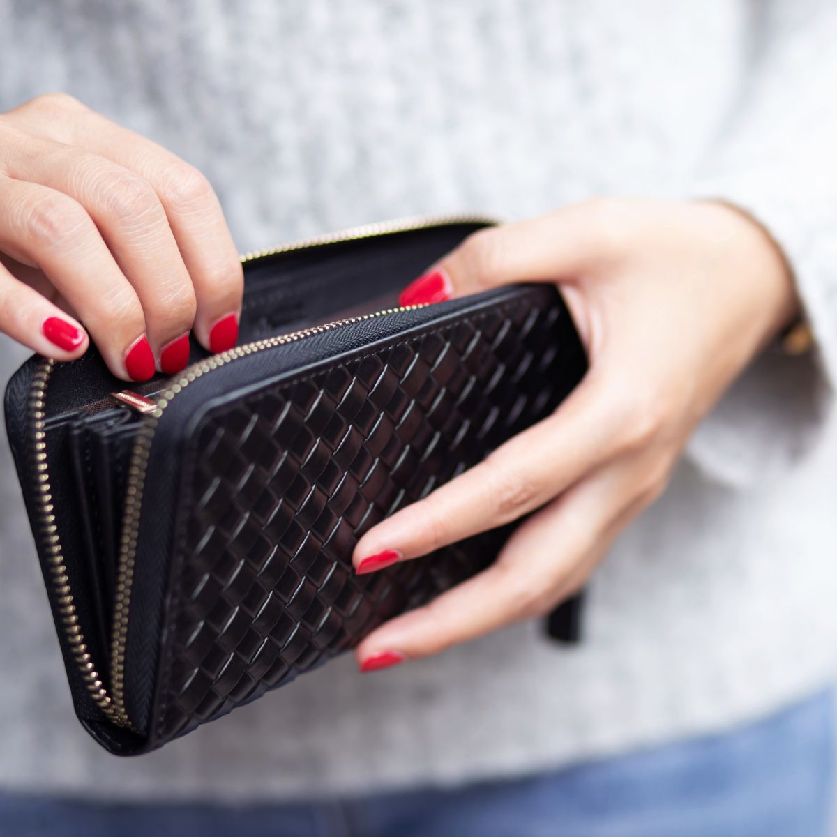female holding a wallet