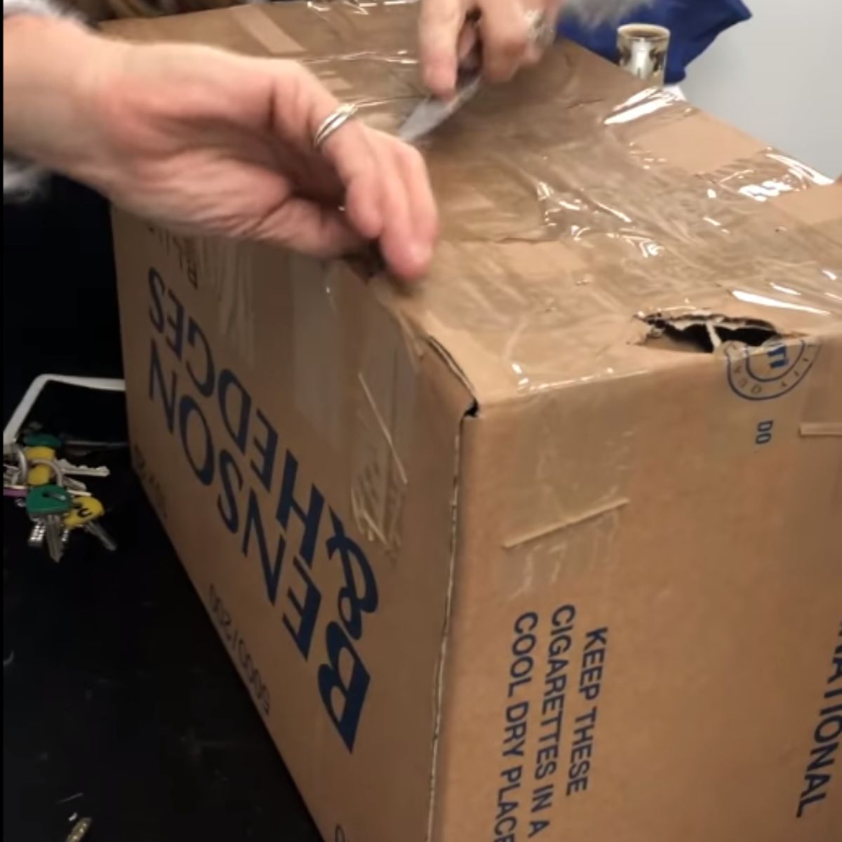 hands opening up a box