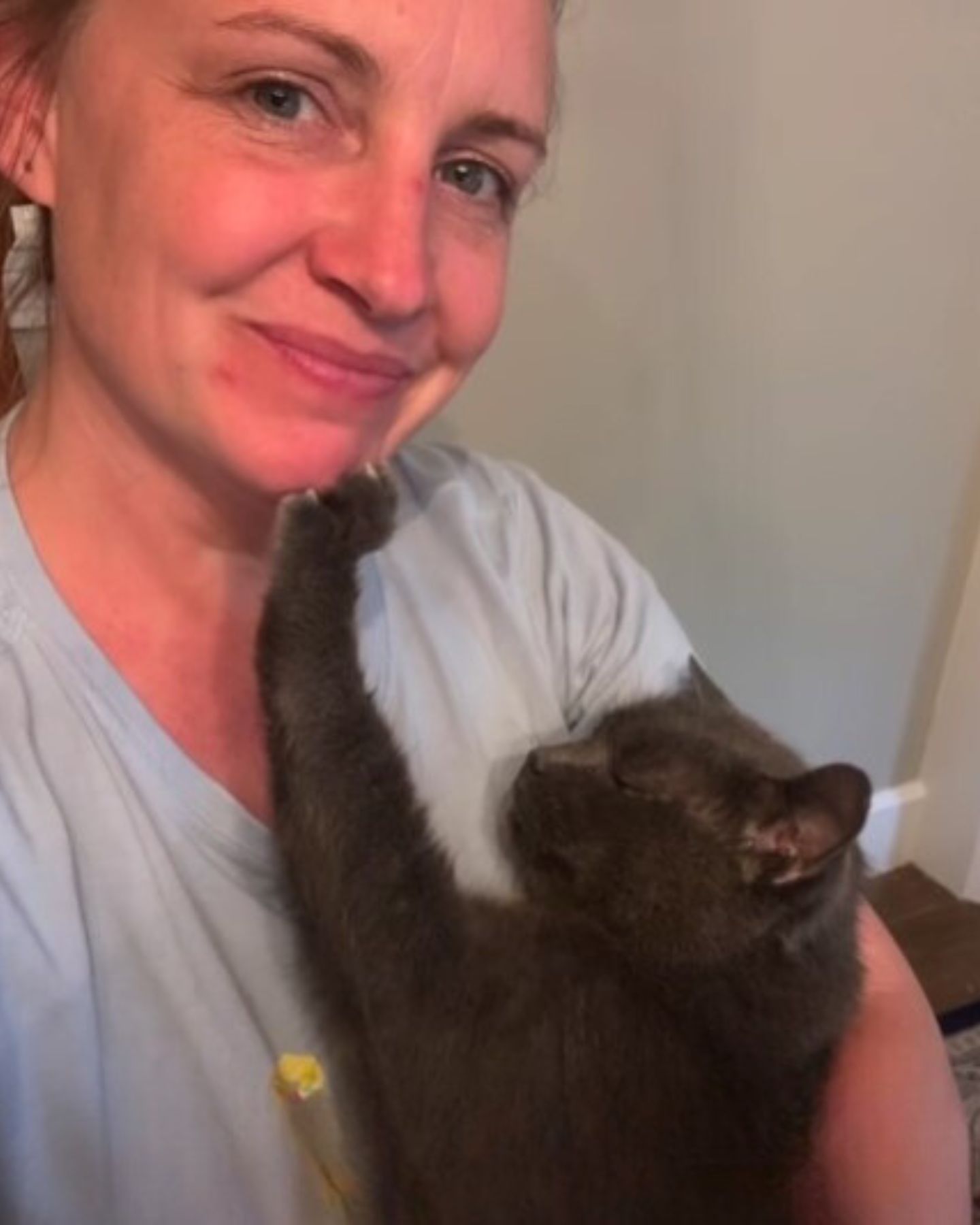 woman holding adorable cat