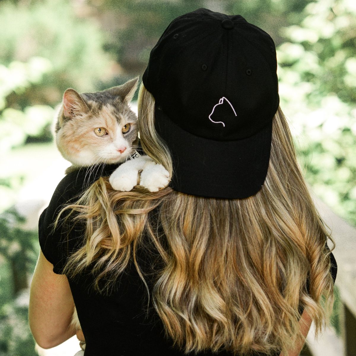 cat on woman's shoulder