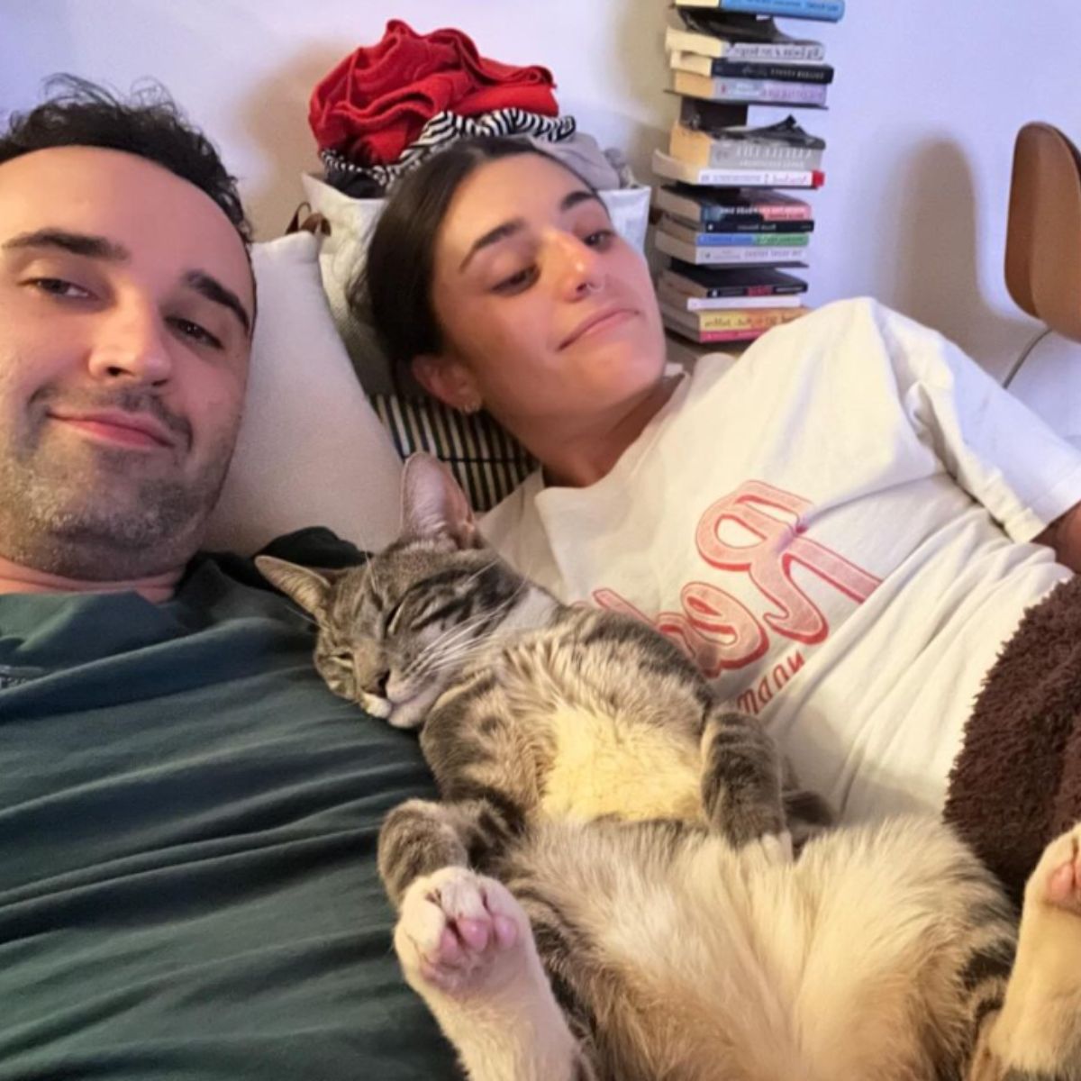 couple and cat in a bed