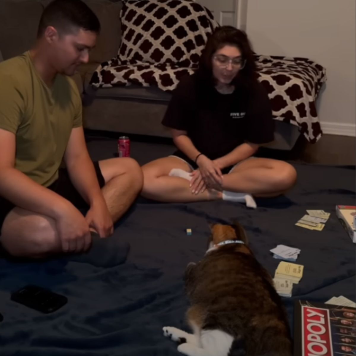 couple playing with cat