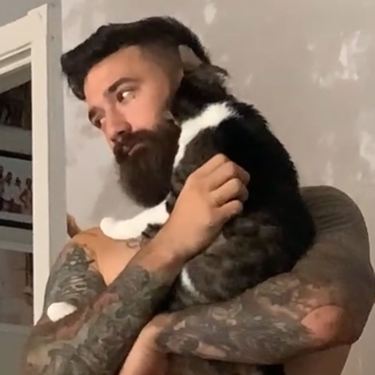 man carrying a cat