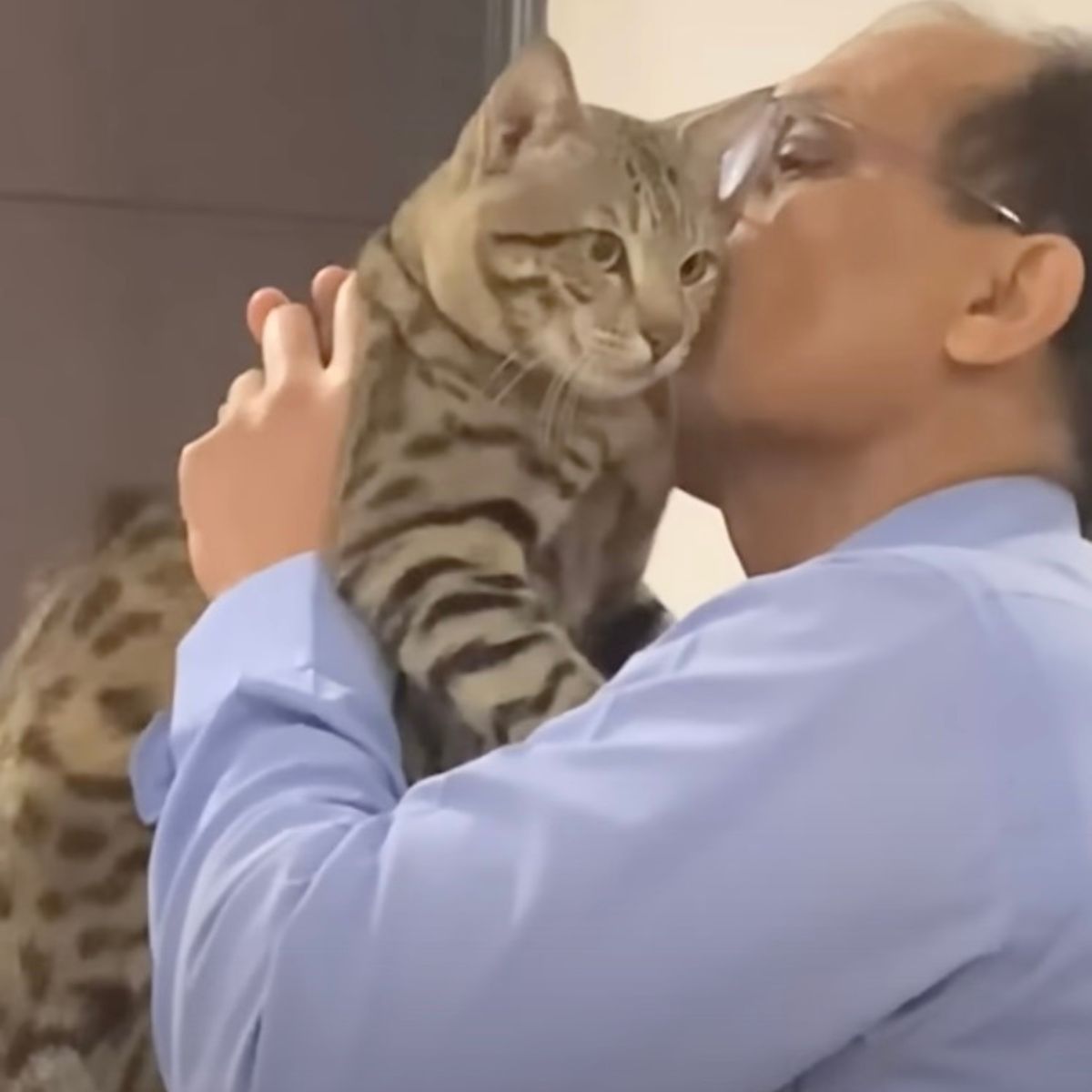 old guy kissing a cat