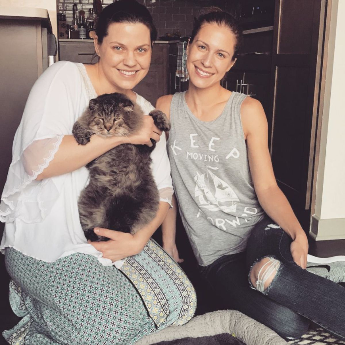 two women and a cat