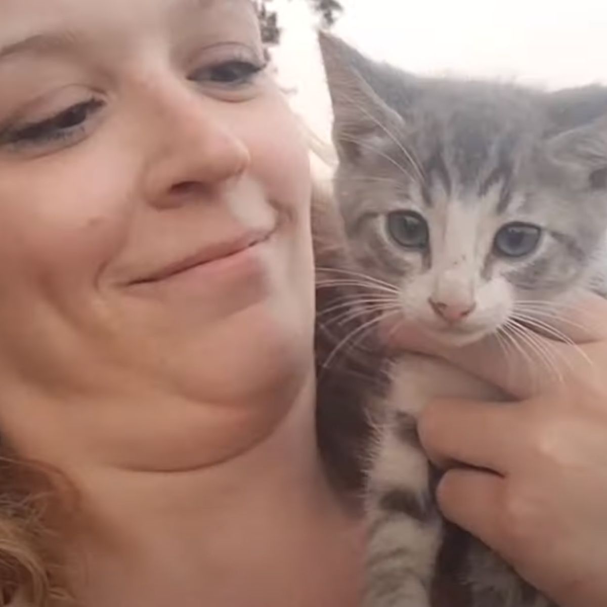 woman holding the kitten