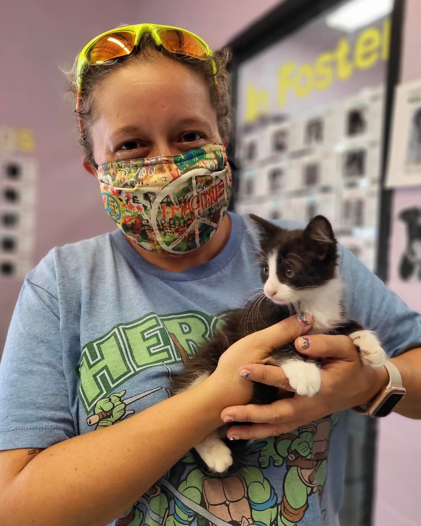 woman with mask holding a kitten