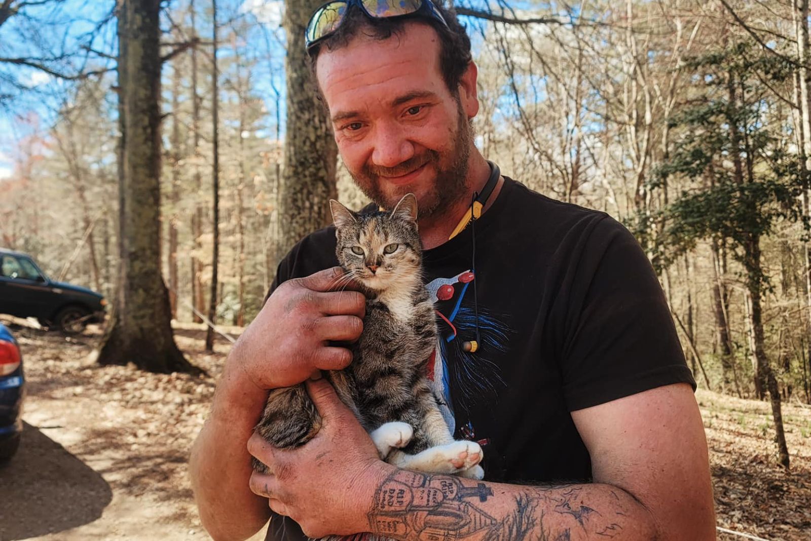 adult guy holding a cat