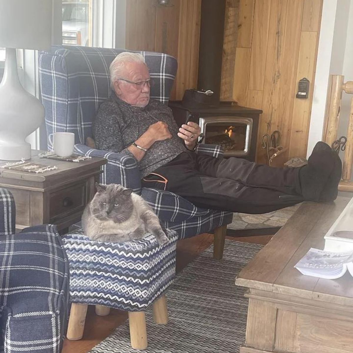 photo of cat and man sitting in livingroom