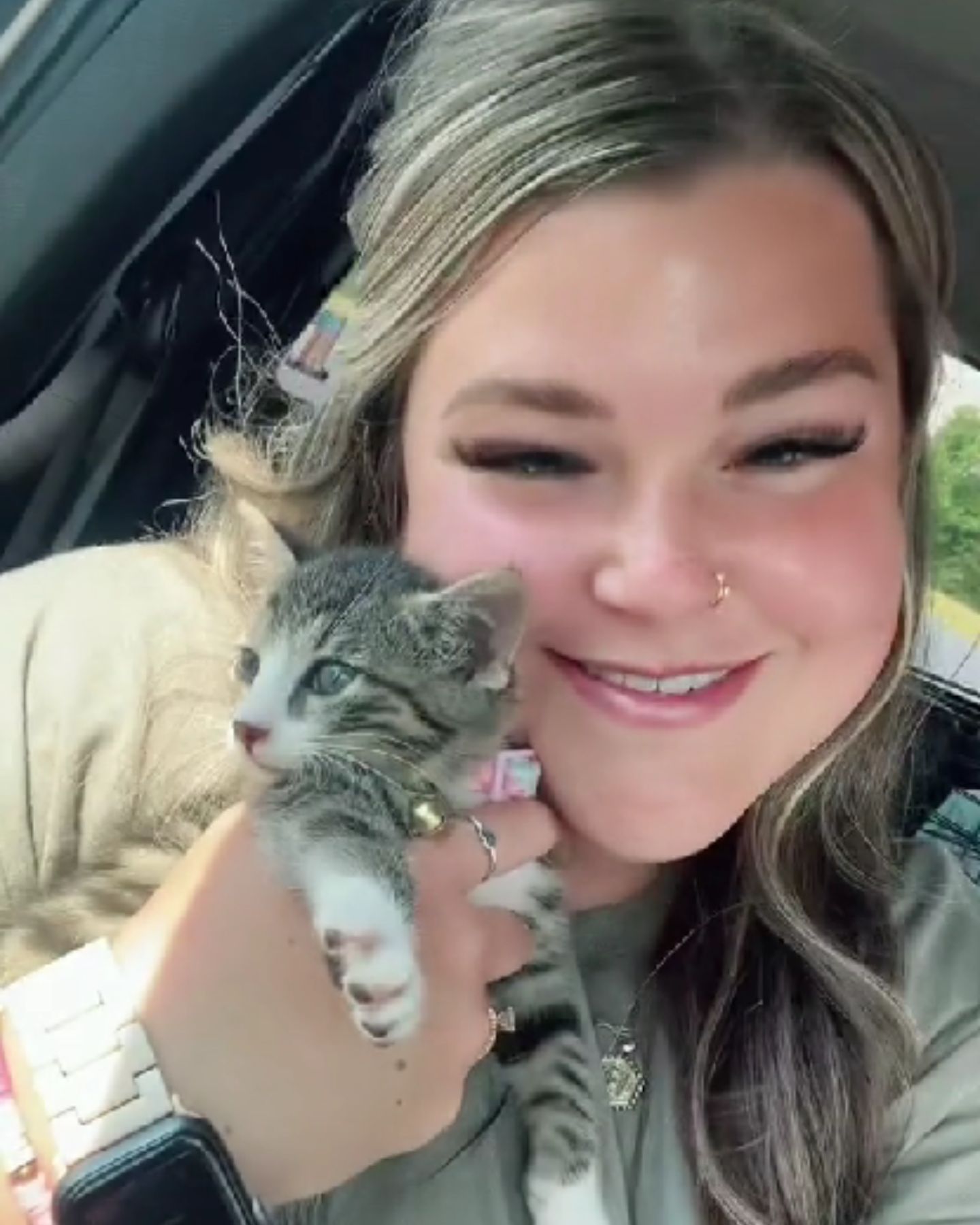 woman and kitten in a car