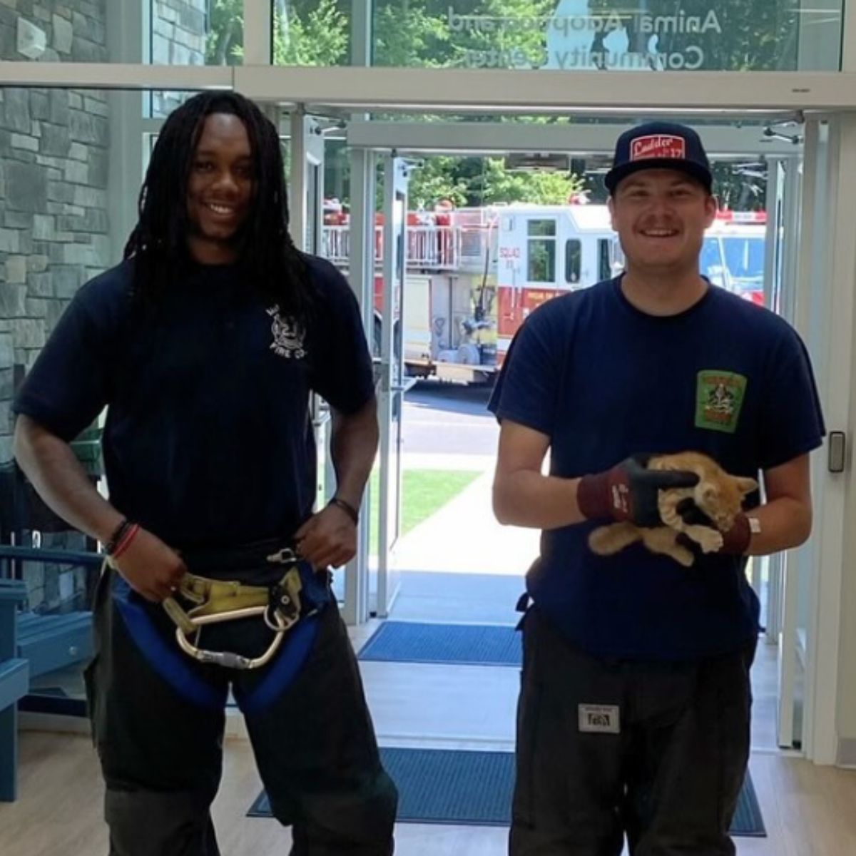 smiling firefighters with kitten