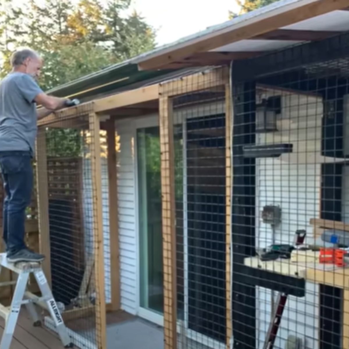 man putting up fence