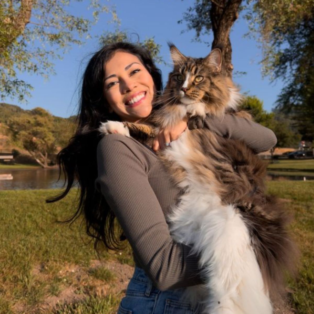 woman holding a giant cat