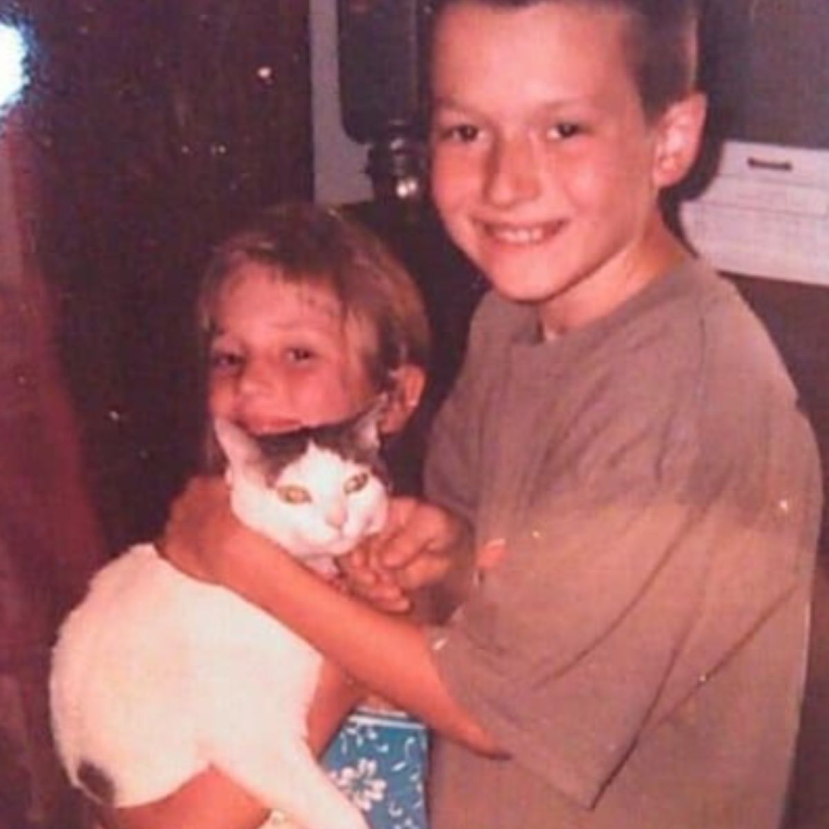 kids holding a cat