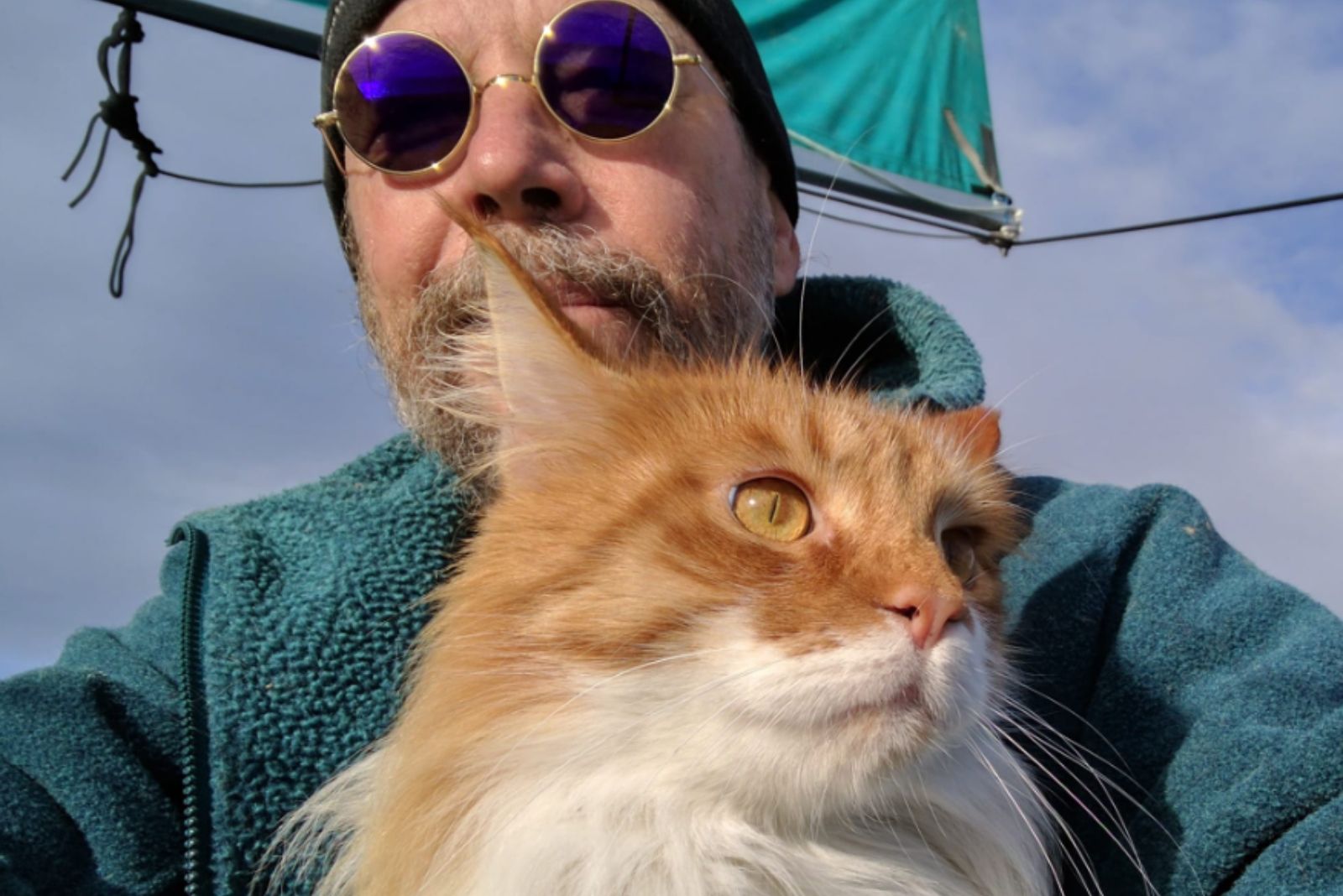 man with glasses and cat