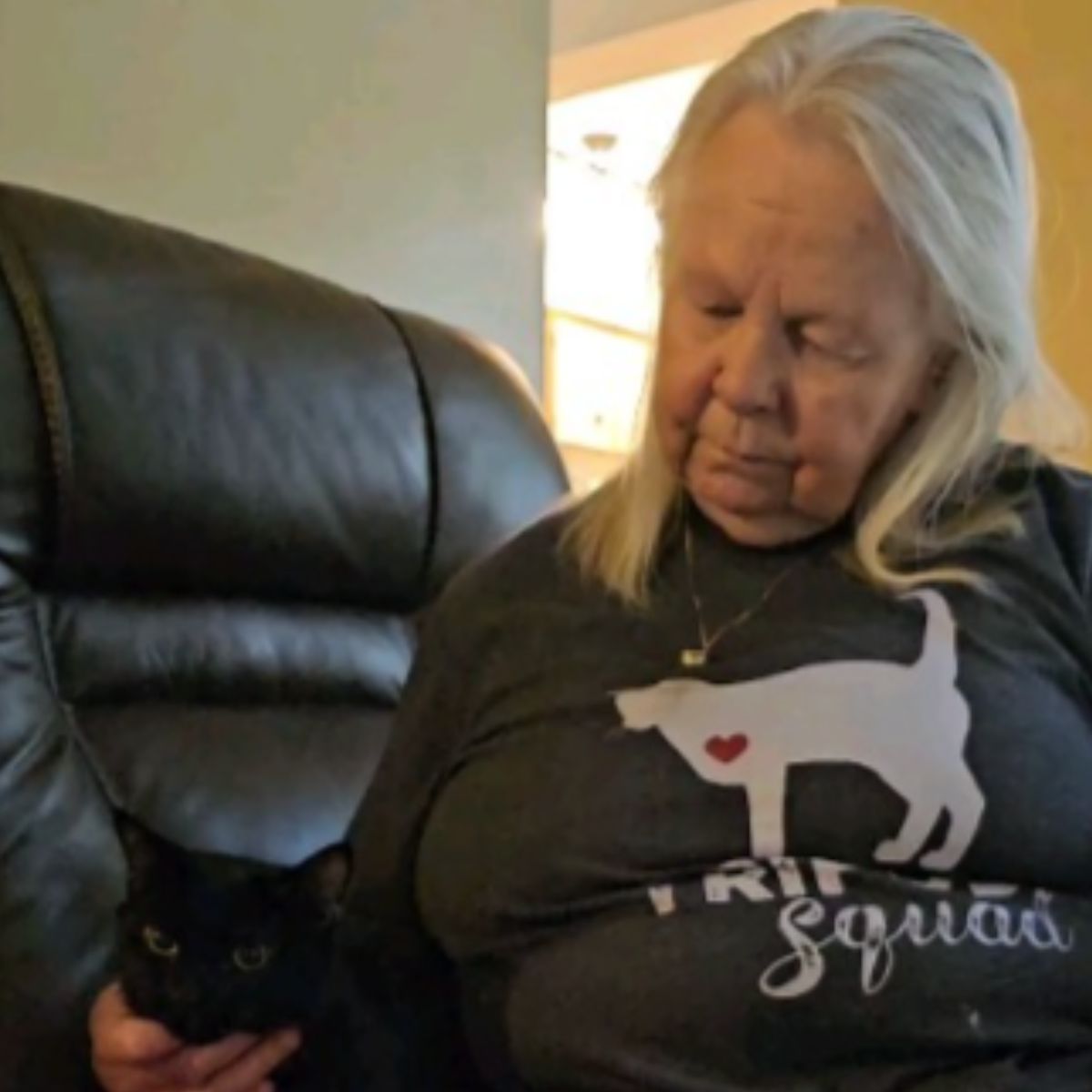 senior woman with cat on the couch