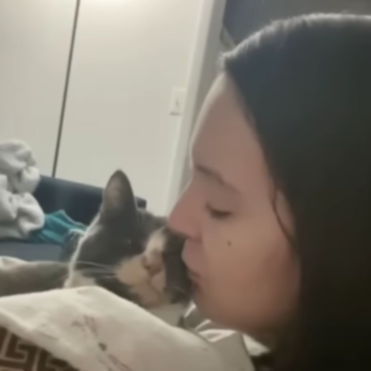 woman kissing cat