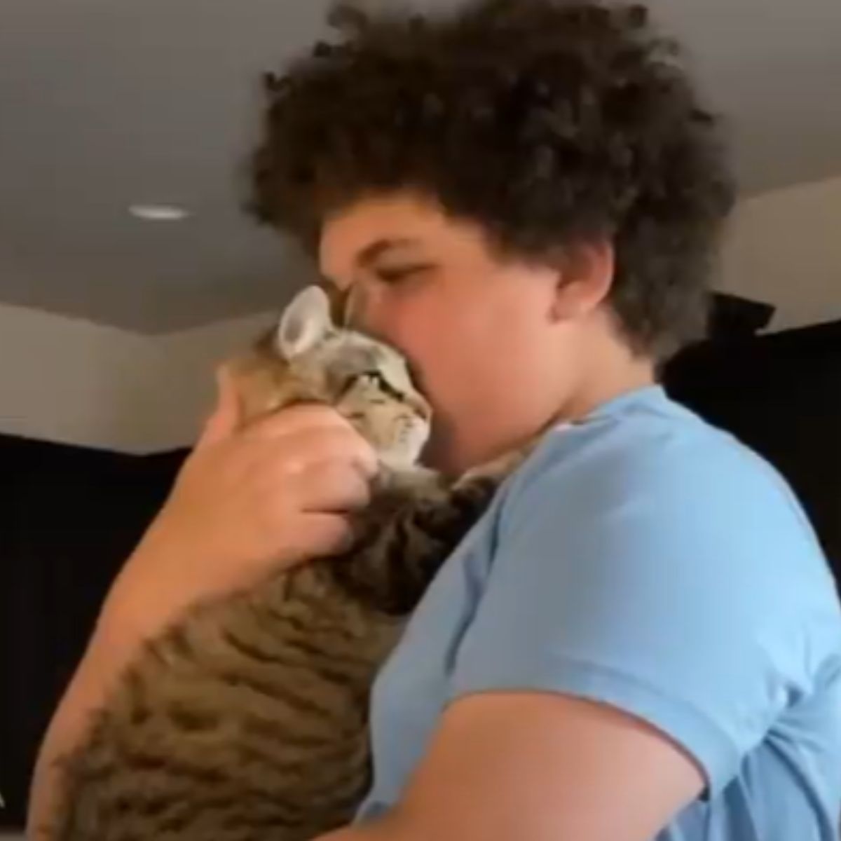 boy holding a cat