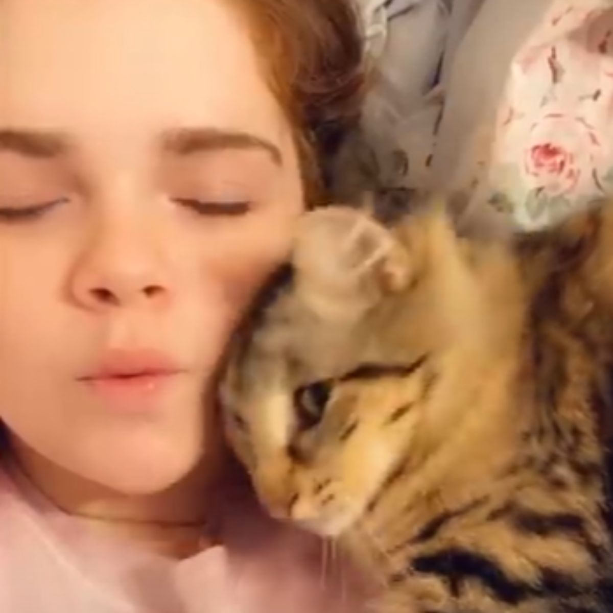 girl cuddling with a cat