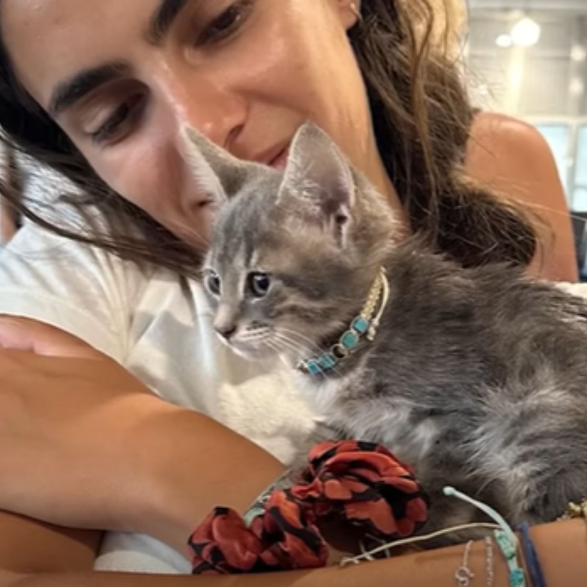 woman looking at kitten