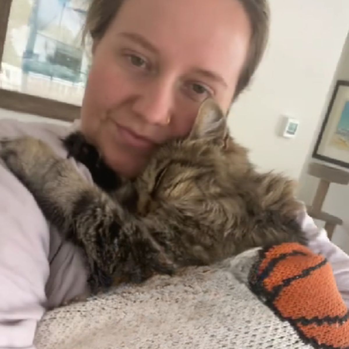 woman snuggling with cat