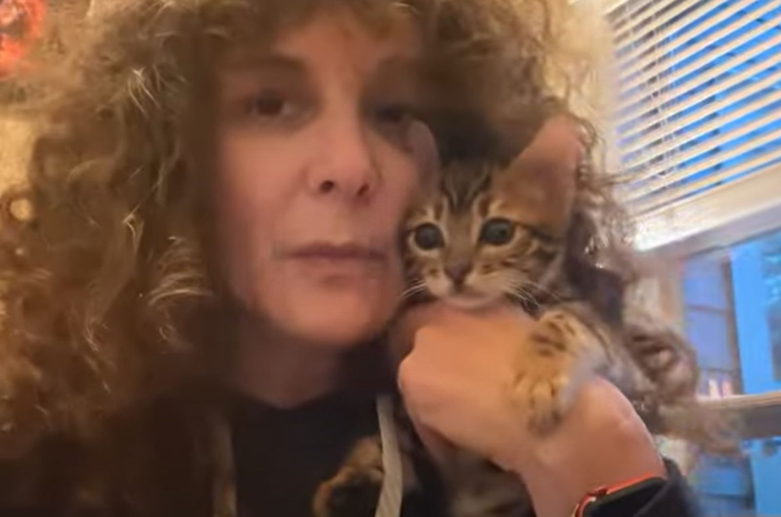 woman with curly hair and cat