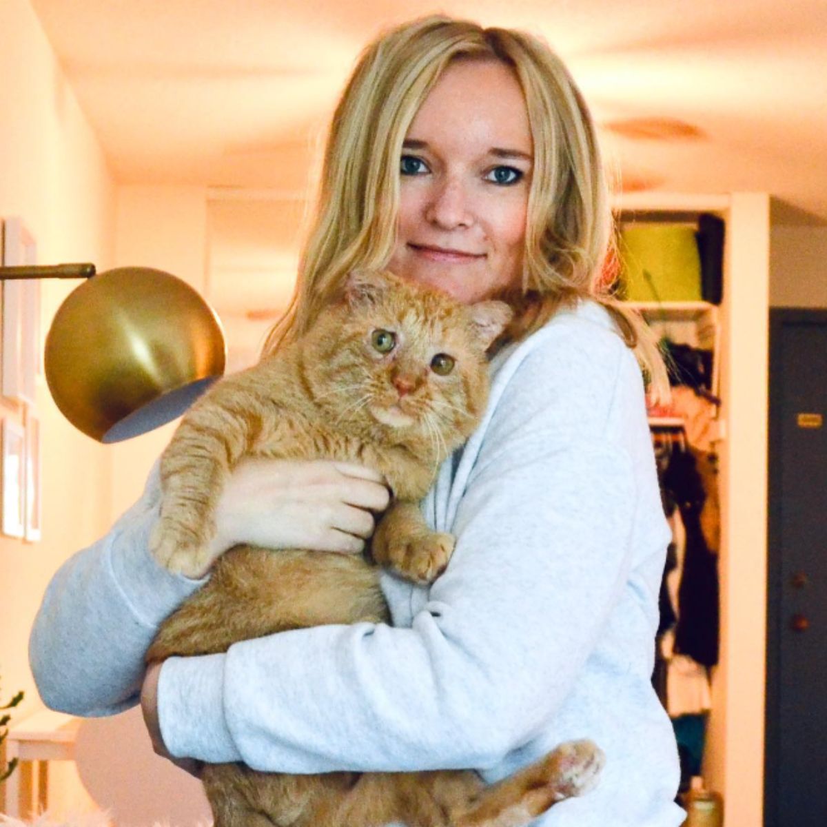 blonde woman and ginger cat