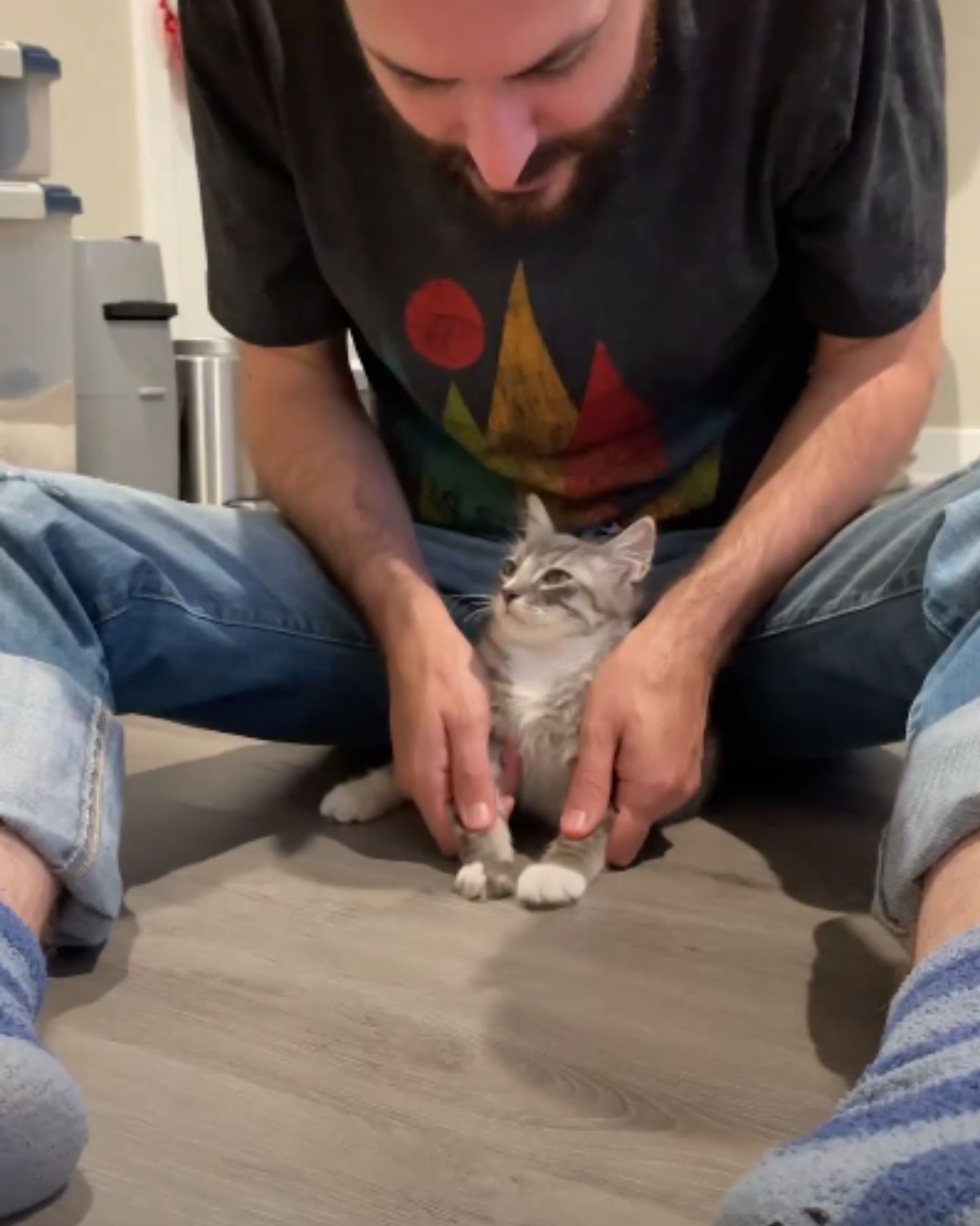 man and gray kitten