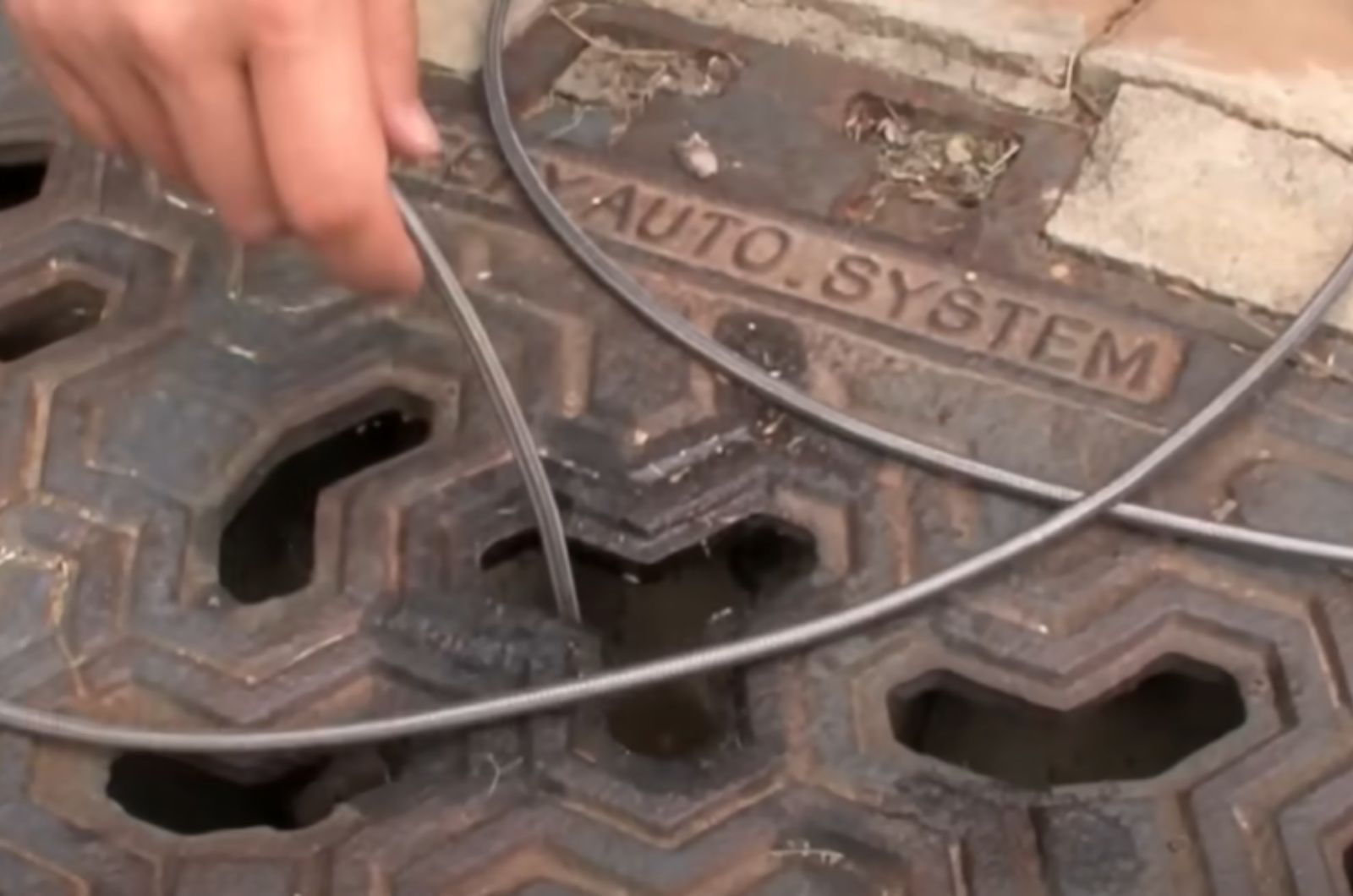 man checking a sewer