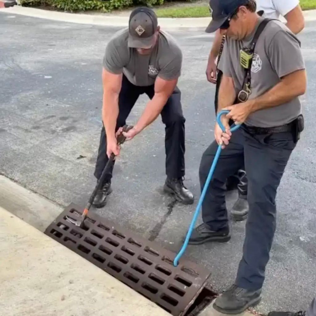 the firemen are blowing up the iron grate on the road