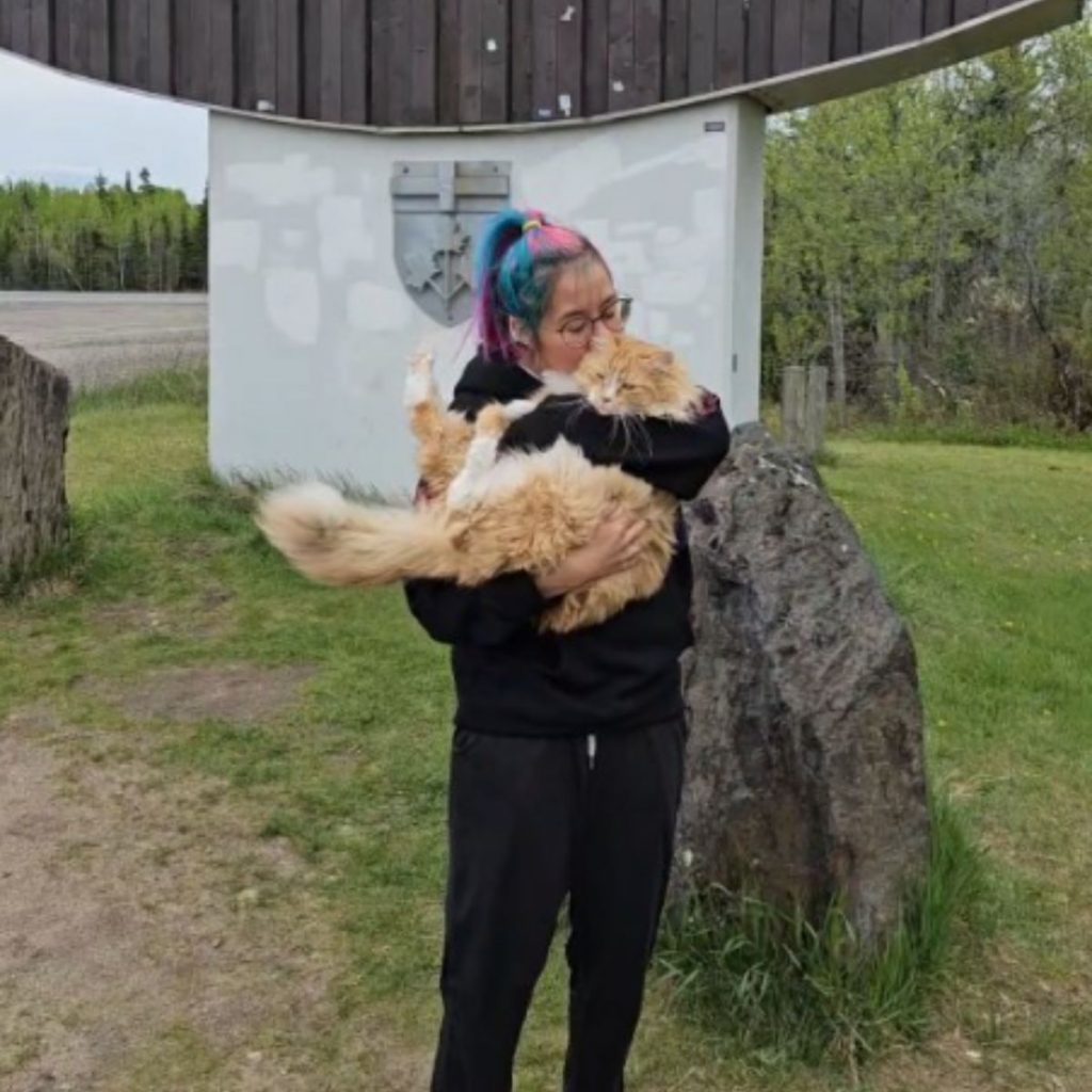 the girl is holding a bear in her arms and kissing it