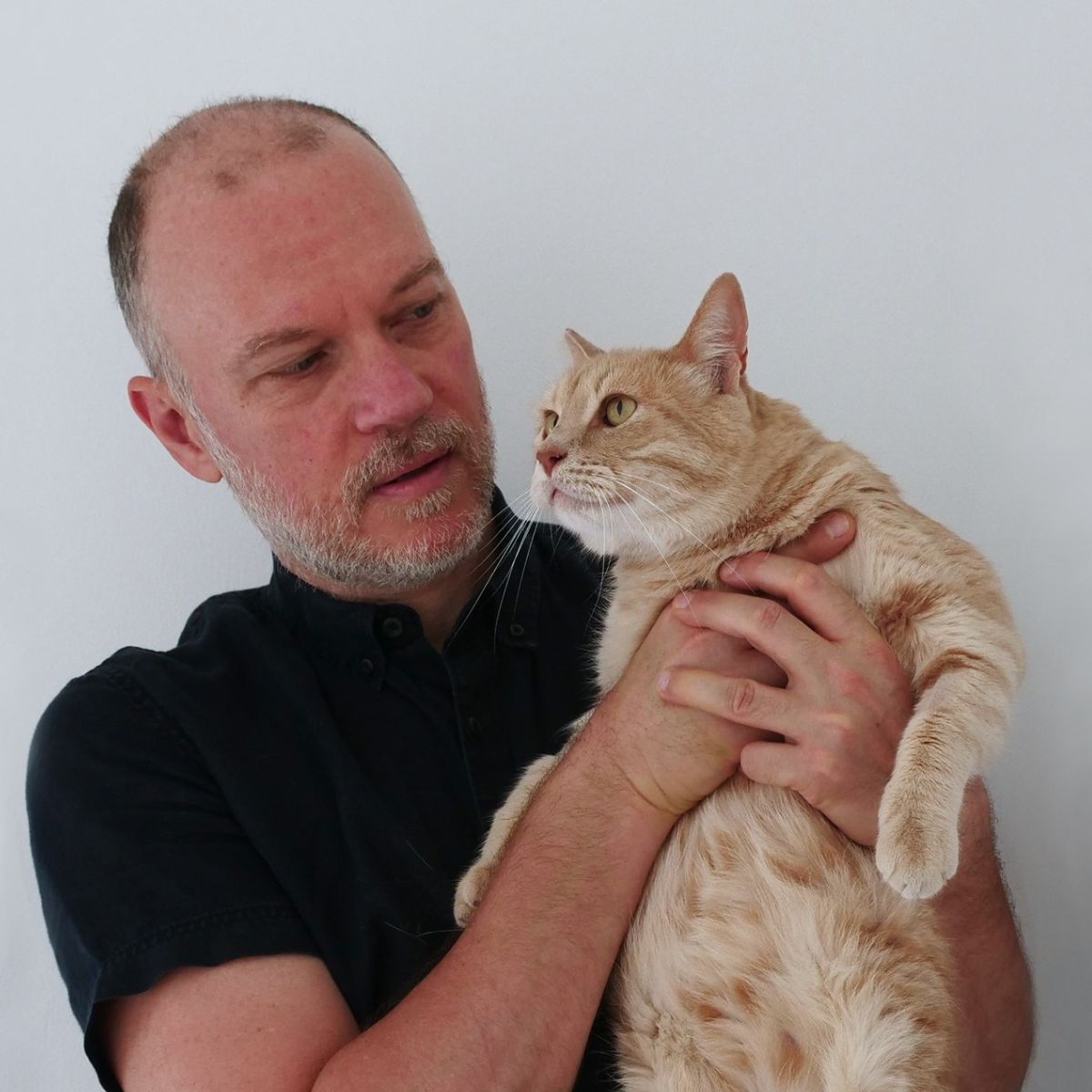 a man holding cat