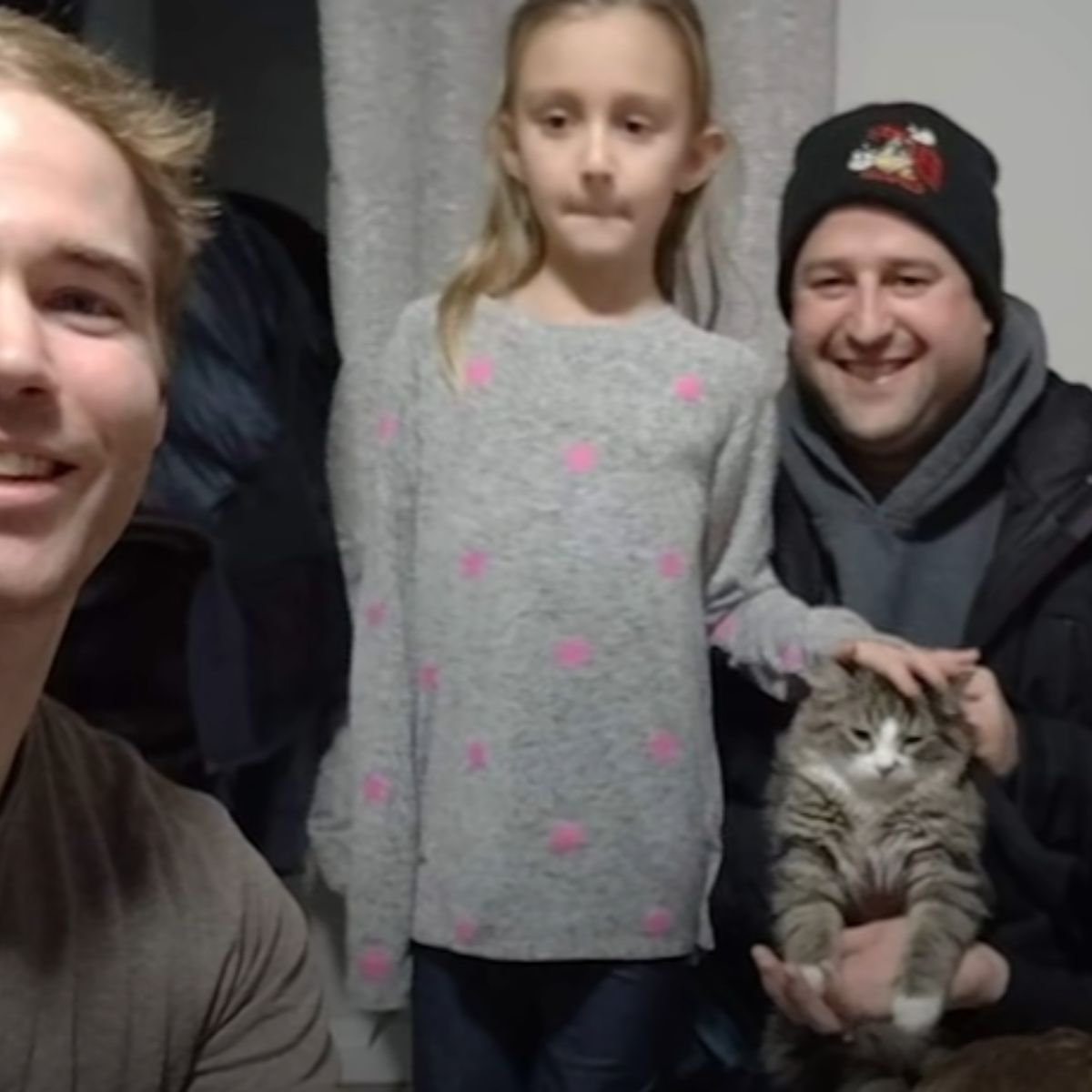 family taking picture with cat