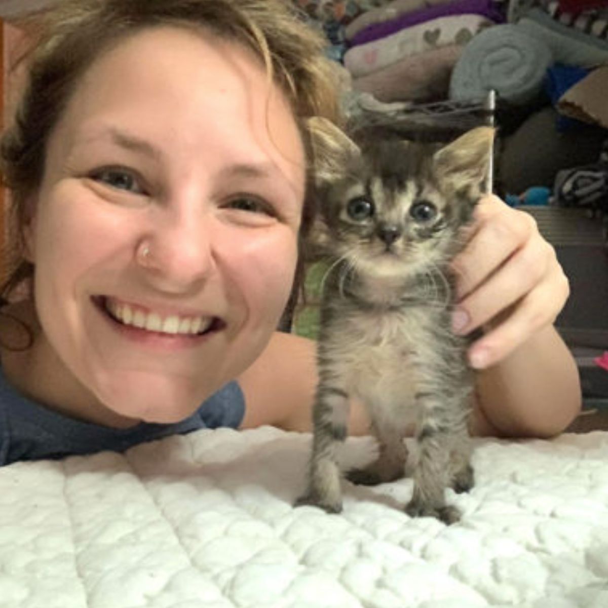 woman and tiny kitten