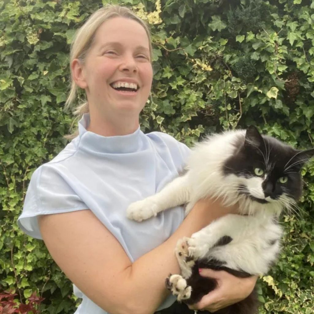 smiling girl with a cat in her arms