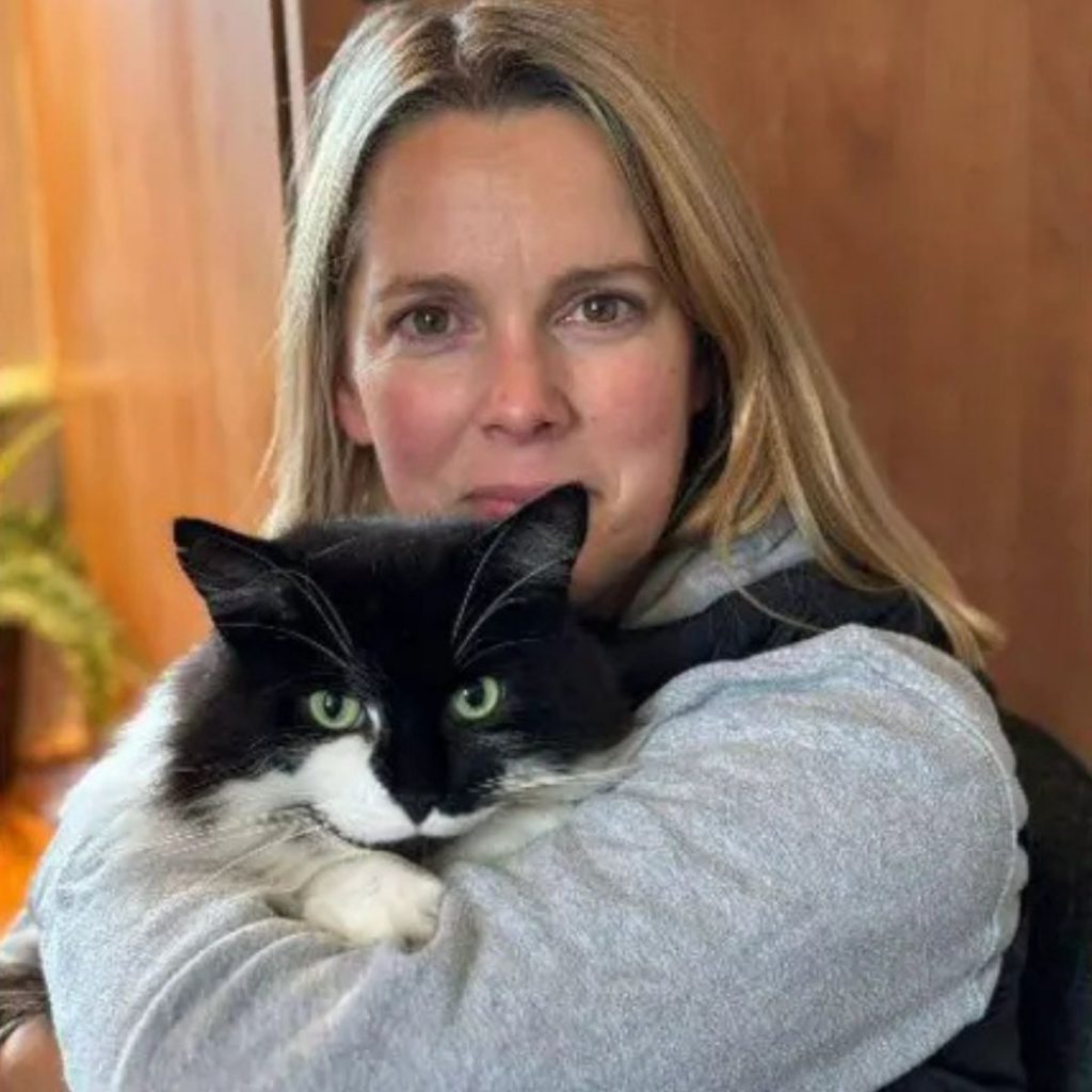 woman holding a cat in her arms