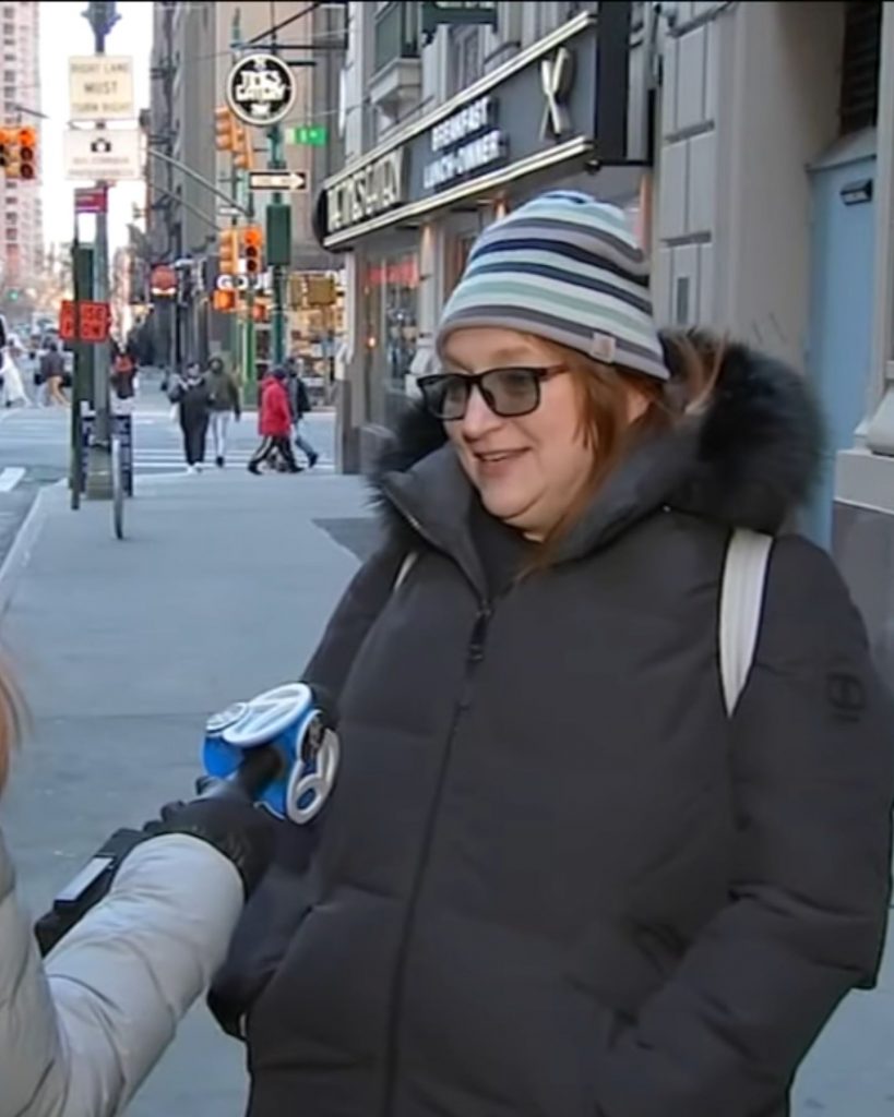 a woman on the street gives an interview